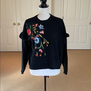 Black embroidered sweater.